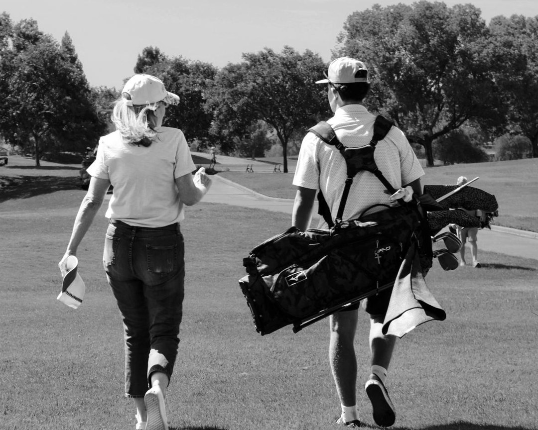 Michelle Kubo walking a golf course with her grandson